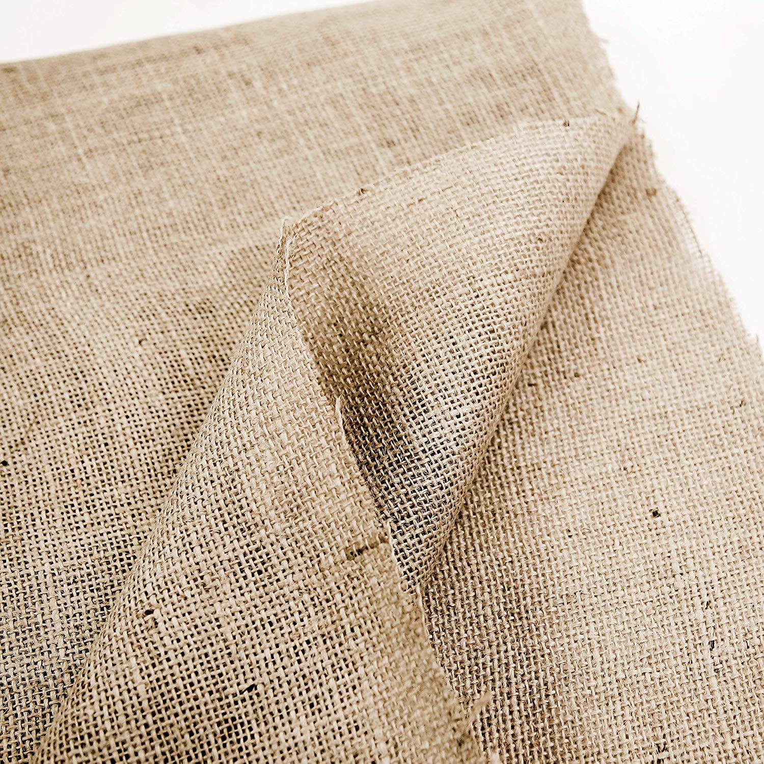 Natural jute burlap wedding aisle runner laid out for an outdoor ceremony